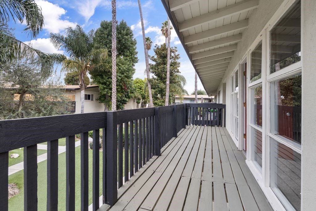 the view from the balcony of a house with a wooden deck