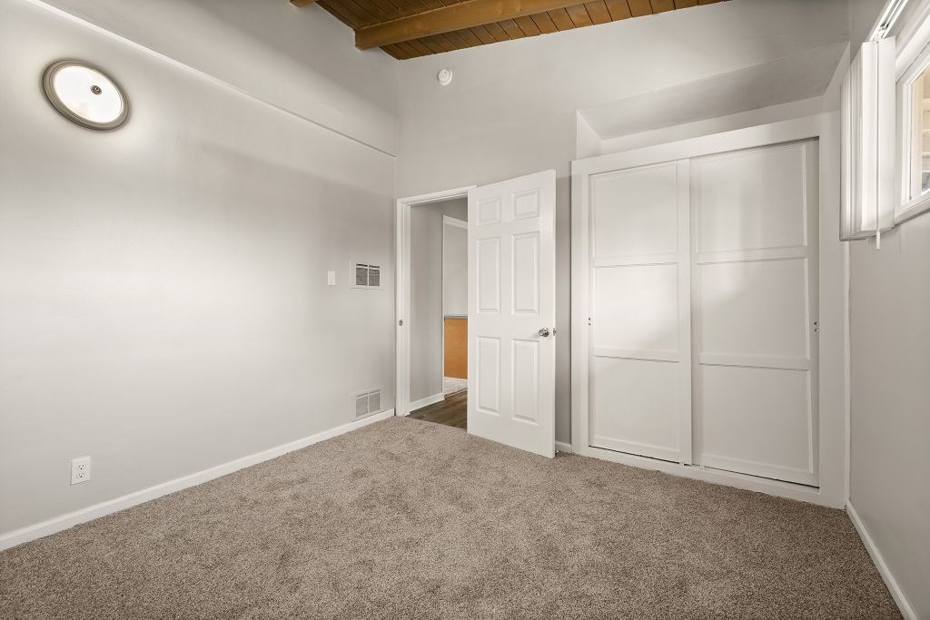 A room with a white door and a window.