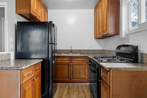 a kitchen with black appliances and wooden cabinets