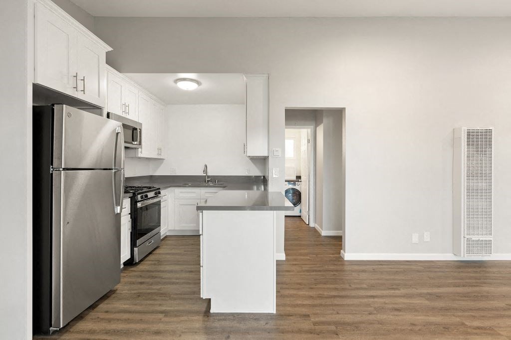 a kitchen with stainless steel appliances and white cabinets