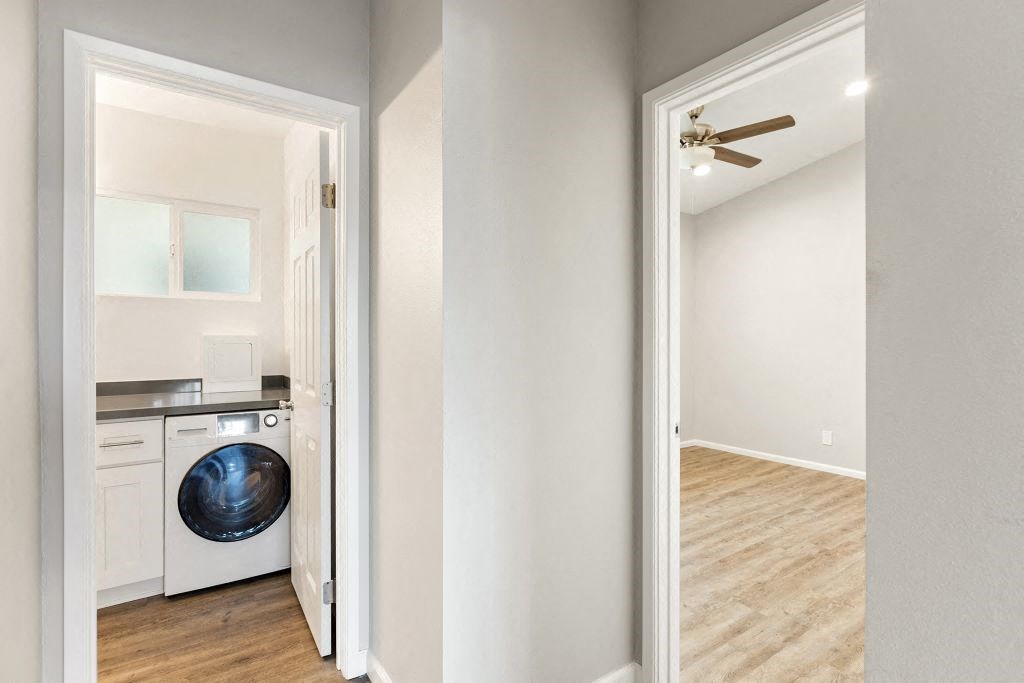 a white laundry room with a washer and dryer in it