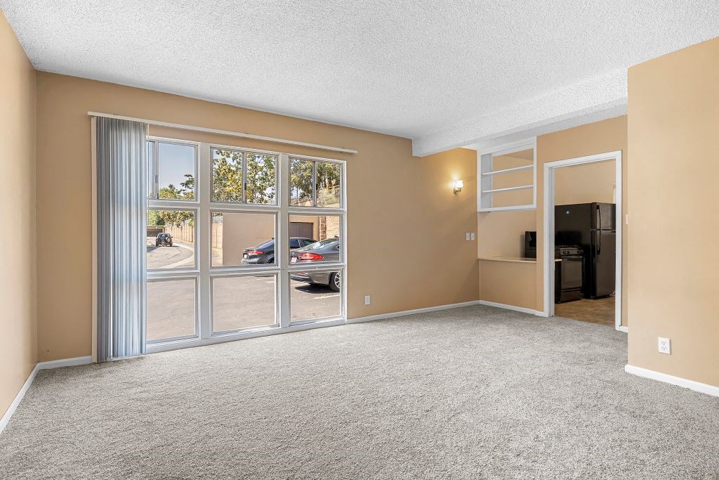 an empty living room with a large window