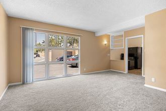 an empty living room with a large window - Photo Gallery