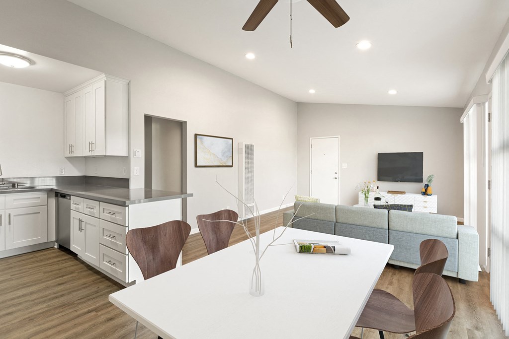 a living room with a kitchen and a dining table