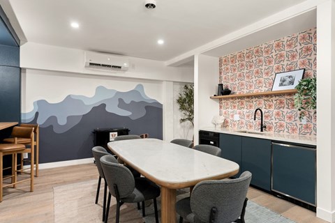 A dining room with a table and chairs.