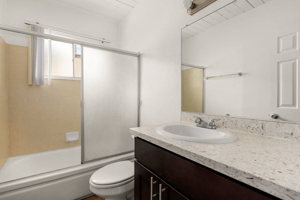 a bathroom with a sink toilet and shower
