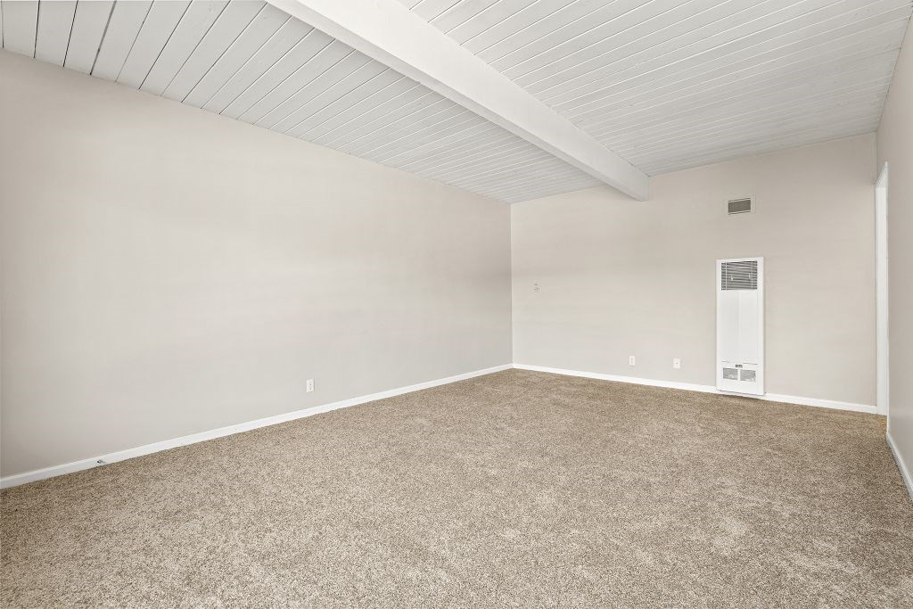 A room with a carpeted floor and a white ceiling.