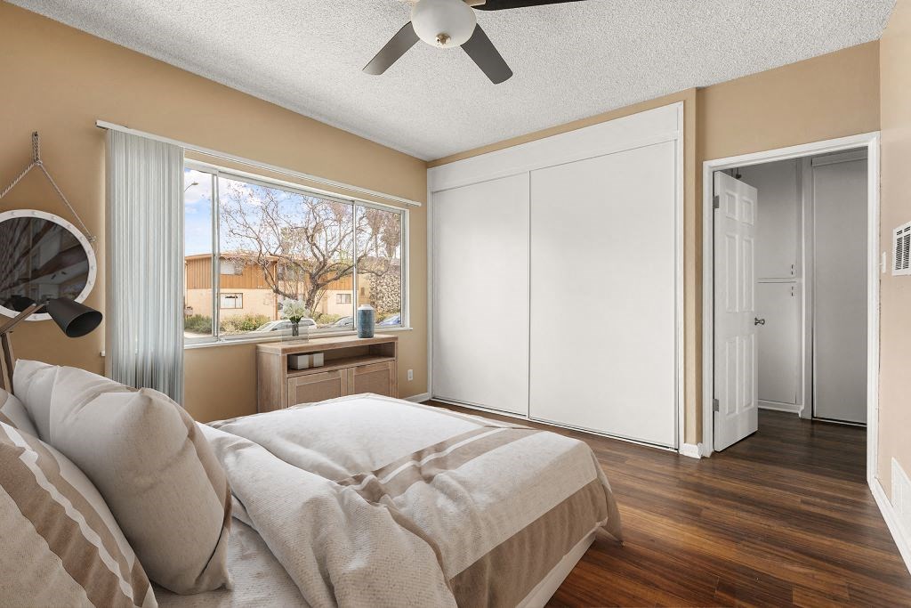 a bedroom with a bed and a ceiling fan