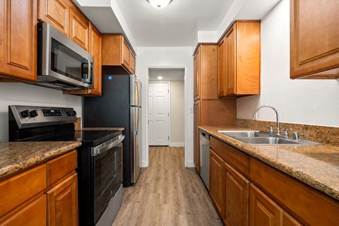a kitchen with wooden cabinets and black appliances