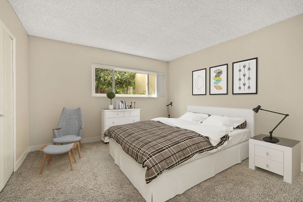 a bedroom with a bed and wallpaper on the wall a bedroom with a bed and wallpaper on the wall at White Oak Terrace Apartments, Encino