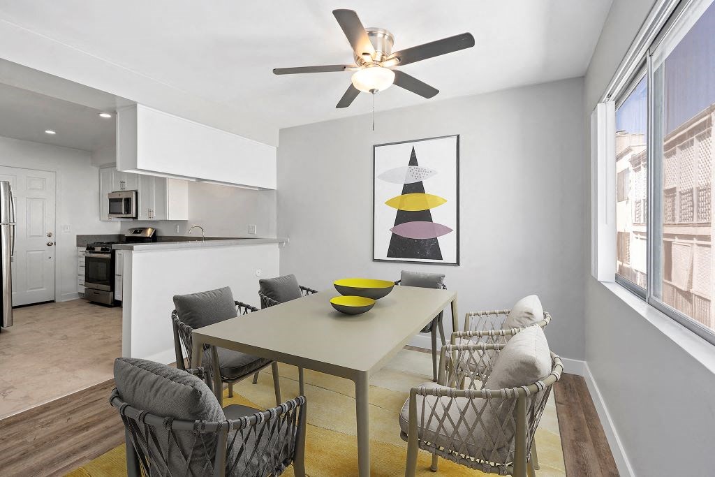 a dining room with a table and a ceiling fan
