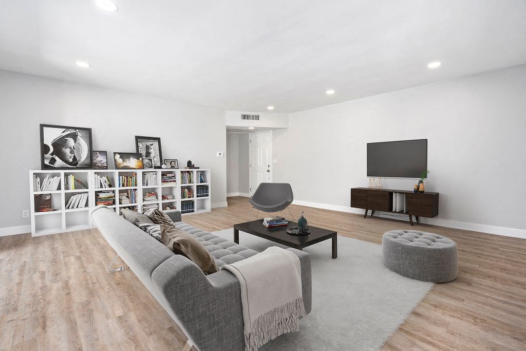 the living room has a large couch and a television