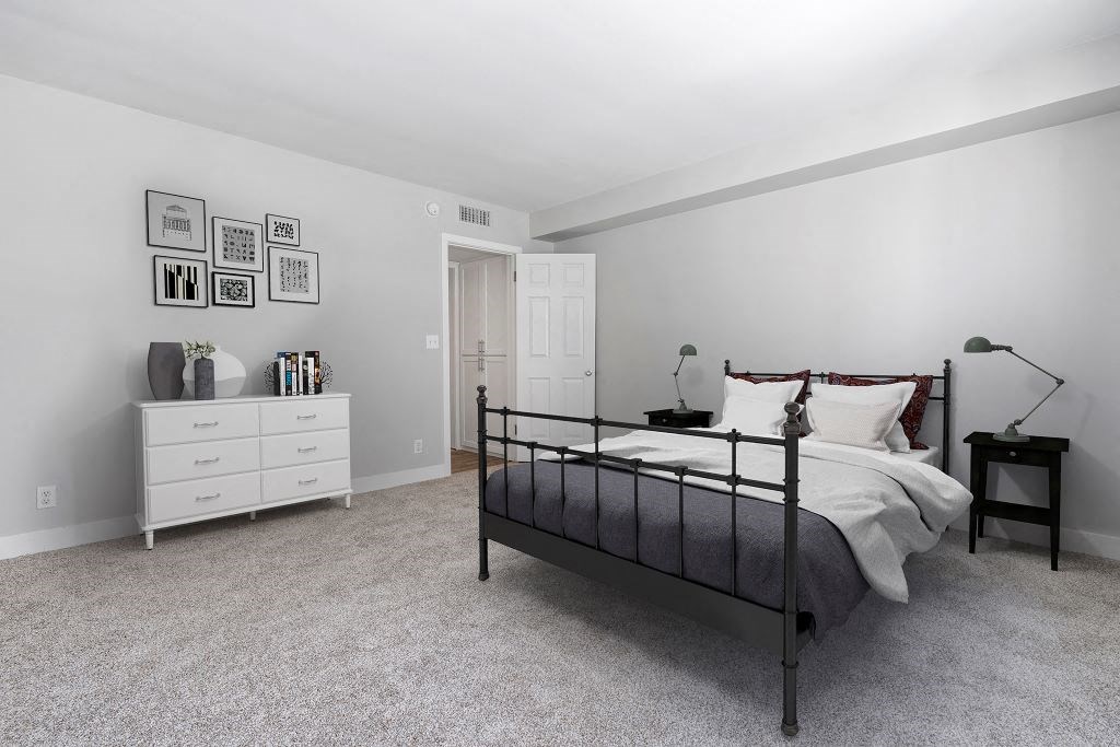 a bedroom with a bed and a dresser