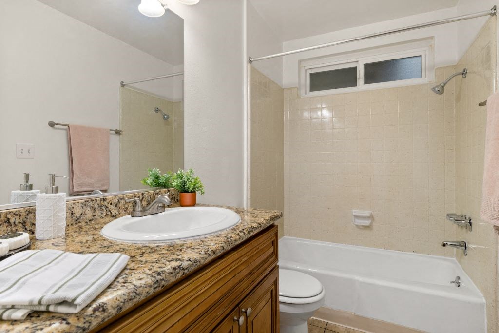 a bathroom with a sink and a toilet and a bath tub at Lombardi Apartments, Woodland Hills, California
