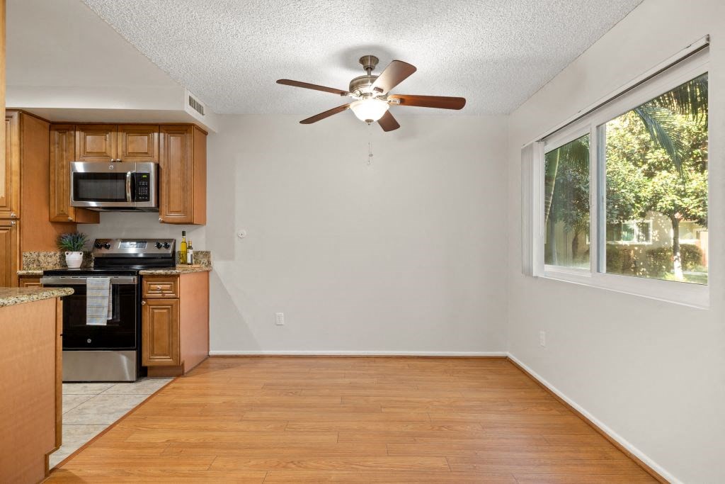 an empty kitchen with a ceiling fan and a window at Lombardi Apartments, Woodland Hills, California