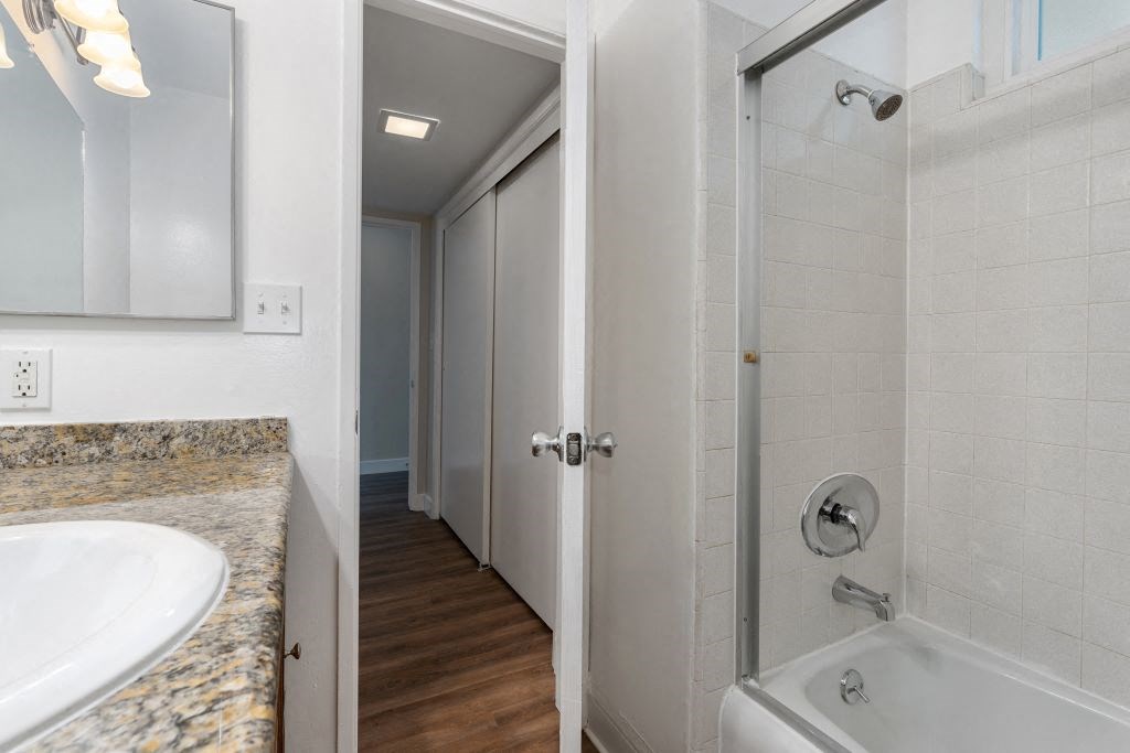 a bathroom with a bathtub and a sink