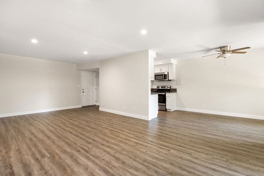 a living room and kitchen with wood flooring and a ceiling fan at Lombardi Apartments, California, 91367
