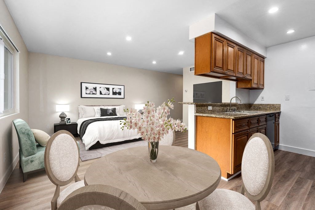 a dining room with a table and chairs and a bedroom at Lombardi Apartments, Woodland Hills