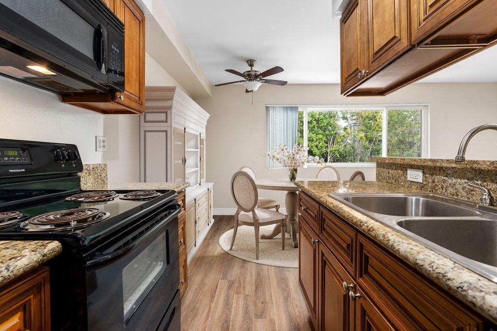 a kitchen with a stove top oven and a sink at Lombardi Apartments, California, 91367