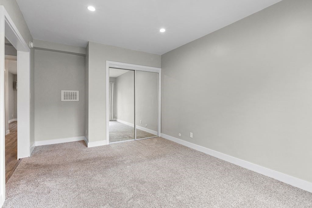 a bedroom with gray walls and a carpeted floor
