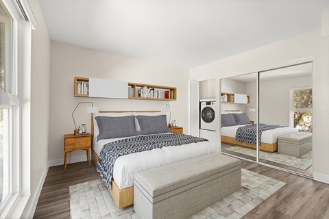 A bedroom with a large bed and a mirrored closet door.