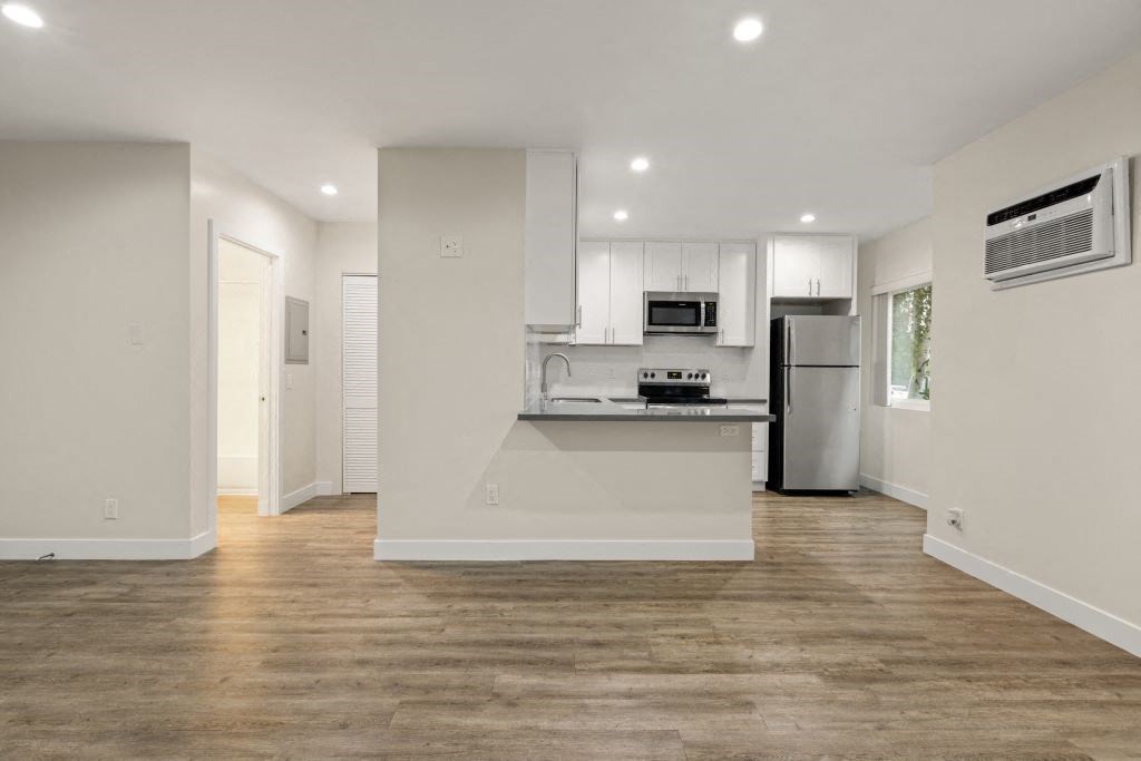 a kitchen with a stove and a refrigerator at Brookside Terrace Apartments, California