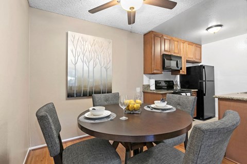 a kitchen and dining room with a table and chairs