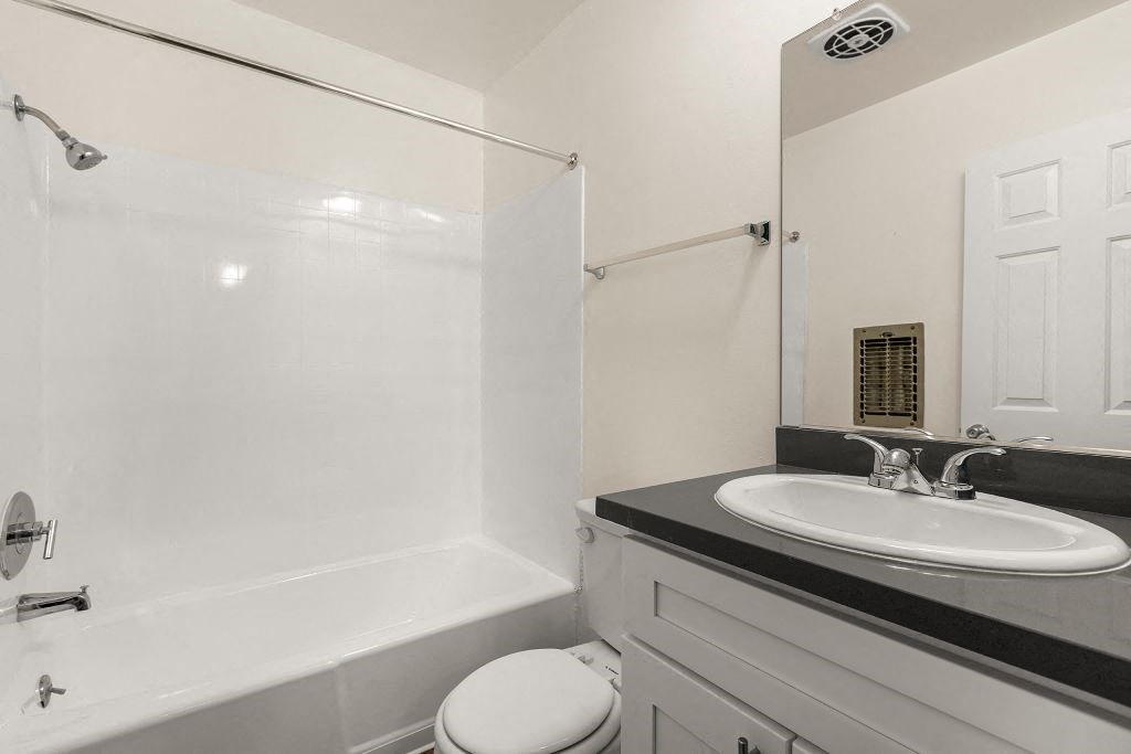 a bathroom with a sink toilet and bathtub