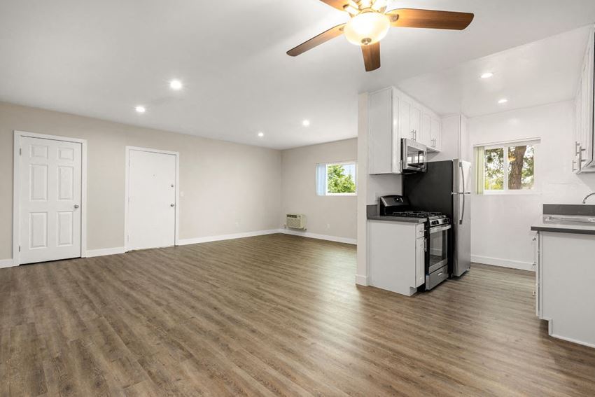 an empty kitchen and living room with a ceiling fan - Photo Gallery 1
