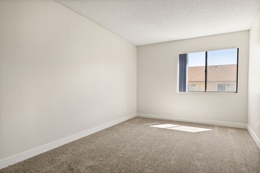 an empty living room with a window