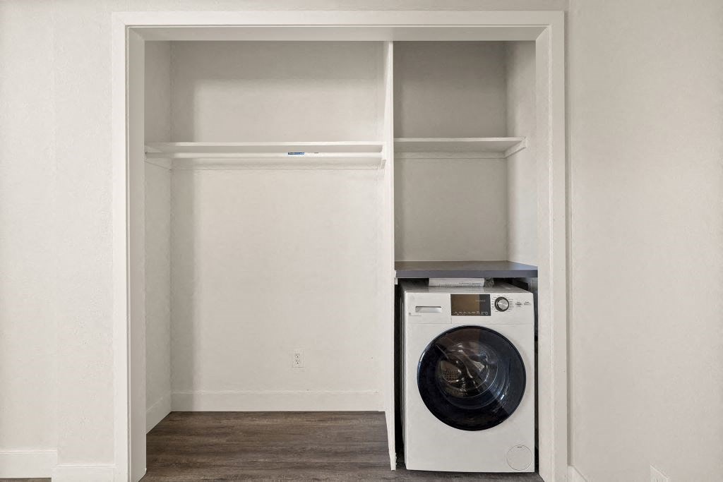 a white washer and dryer in a closet