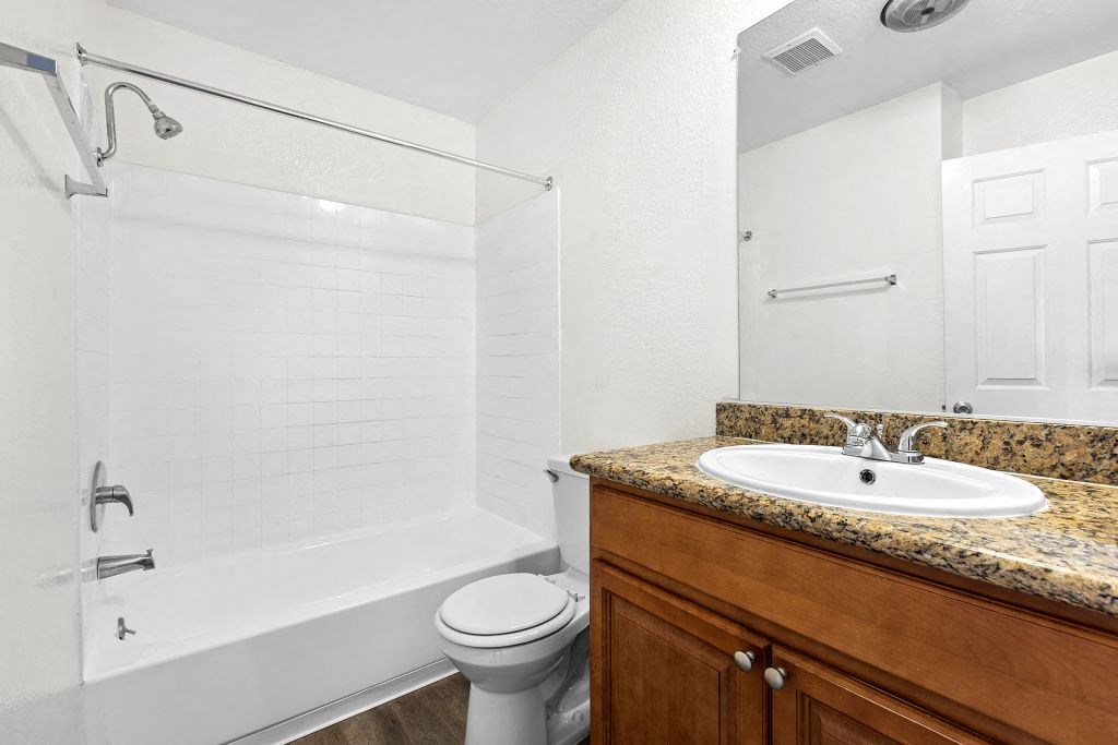 a bathroom with a sink toilet and shower