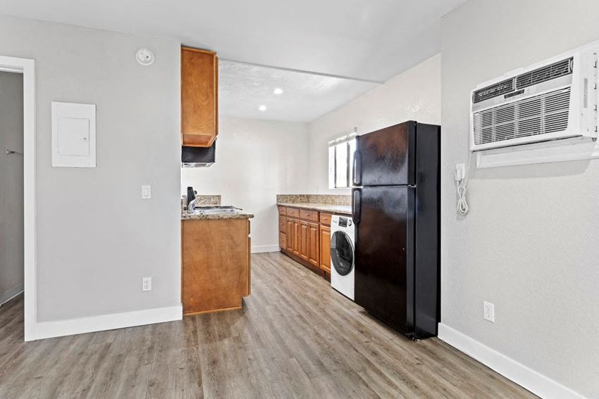 a kitchen with a black refrigerator freezer next to a stove top oven - Photo Gallery