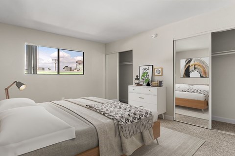 A bedroom with a large bed and a dresser with a mirror.