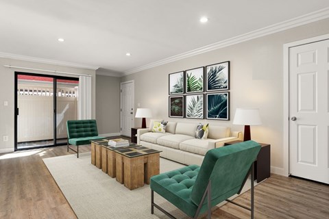 A living room with a green chair and a white couch.
