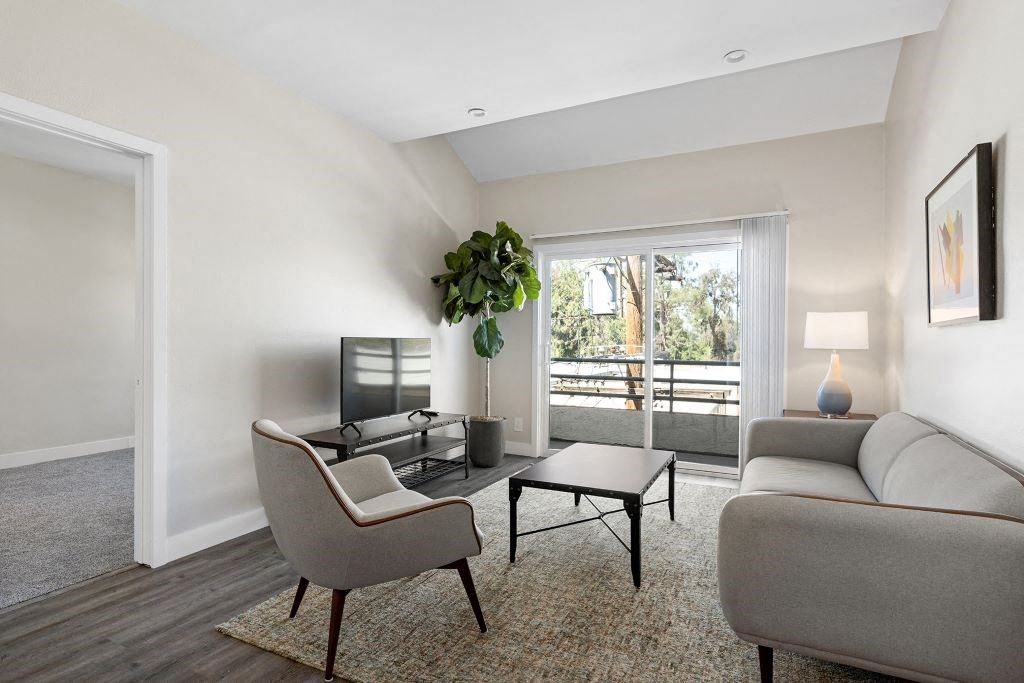 a living room with a couch and a table at Woodland Trio Apartments, California