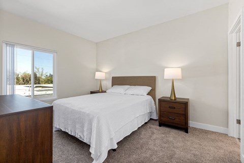 a bedroom with a bed and a window at Woodland Trio Apartments, California