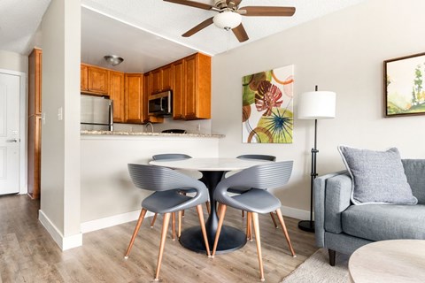 A modern kitchen with a dining table and chairs.