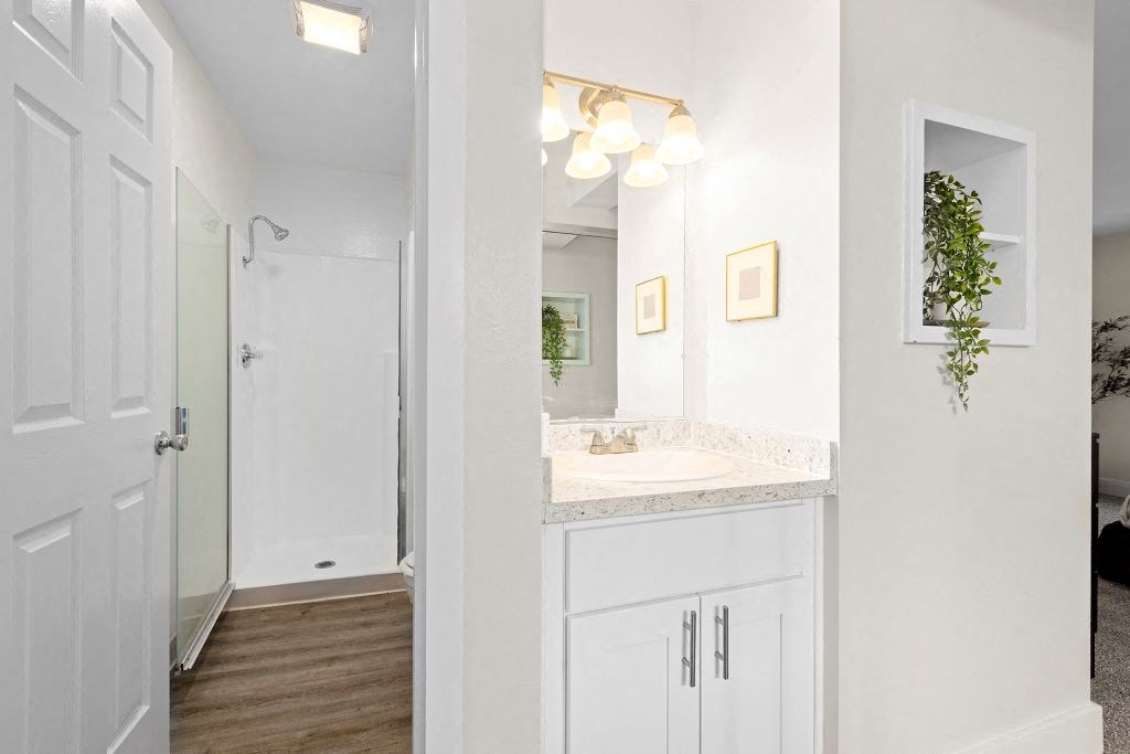A bathroom with a white door and a white counter. at The Meadows at Westlake Village Apartments,Westlake Village, California