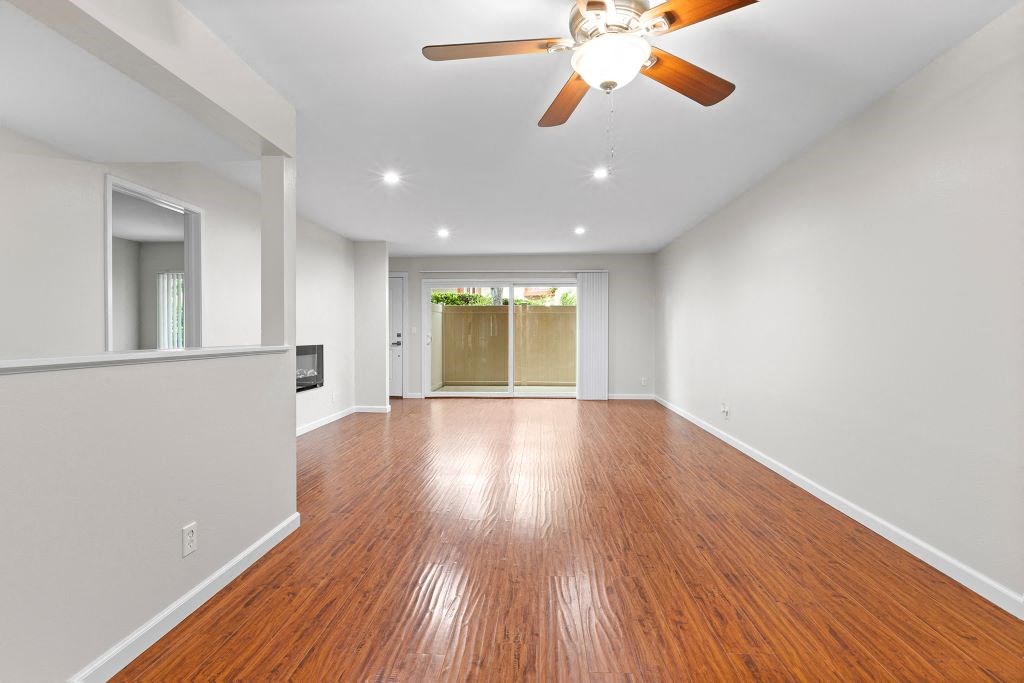 a living room with white walls and a ceiling fan at The Meadows at Westlake Village Apartments,Westlake Village, California