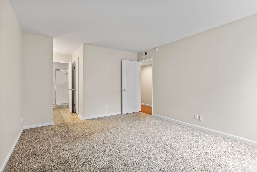 a bedroom with white walls and a carpeted floor at The Meadows at Westlake Village Apartments, Westlake Village, CA