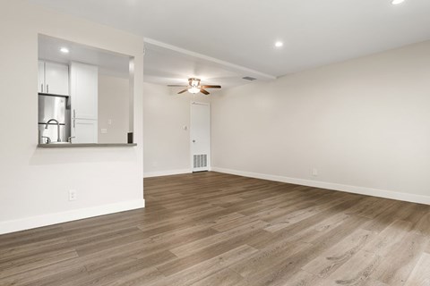 A room with a wooden floor and a ceiling fan.