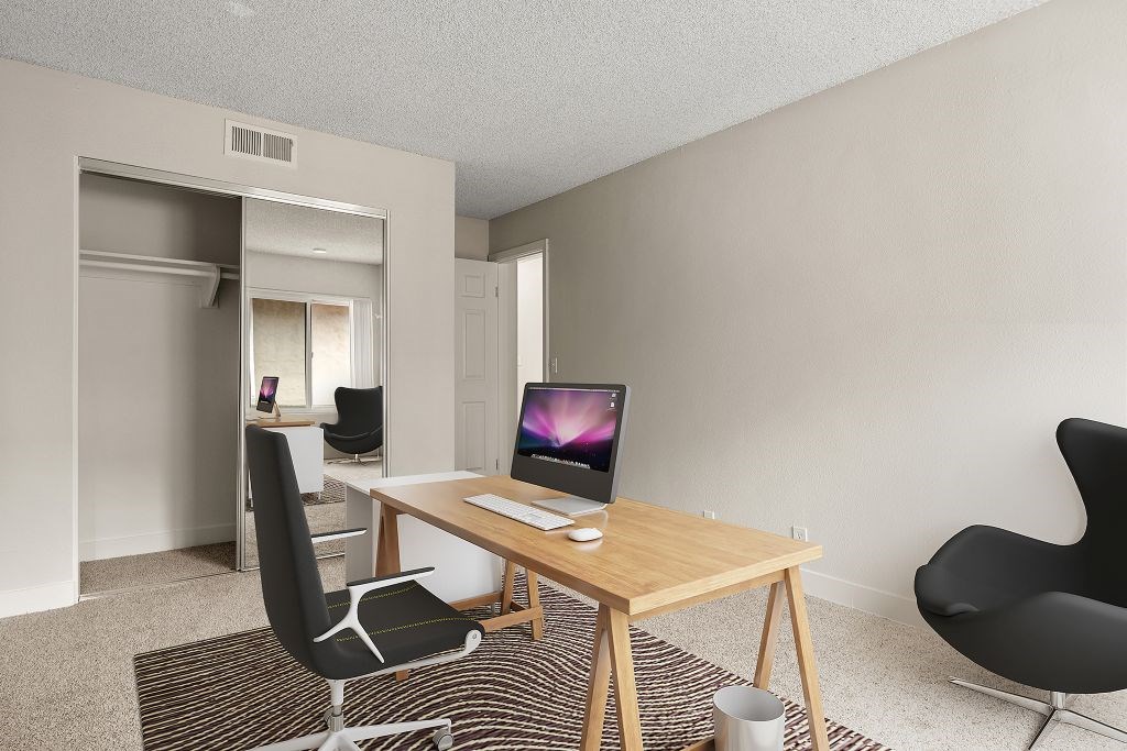 A room with a desk and a chair.