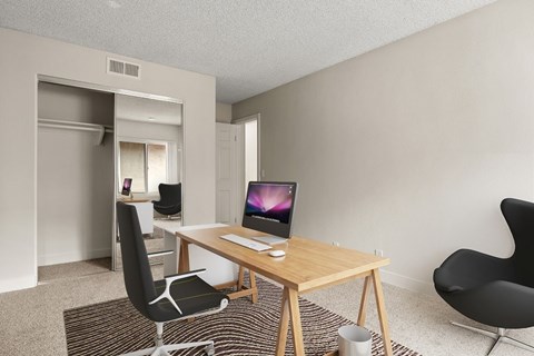 A room with a desk and a chair.