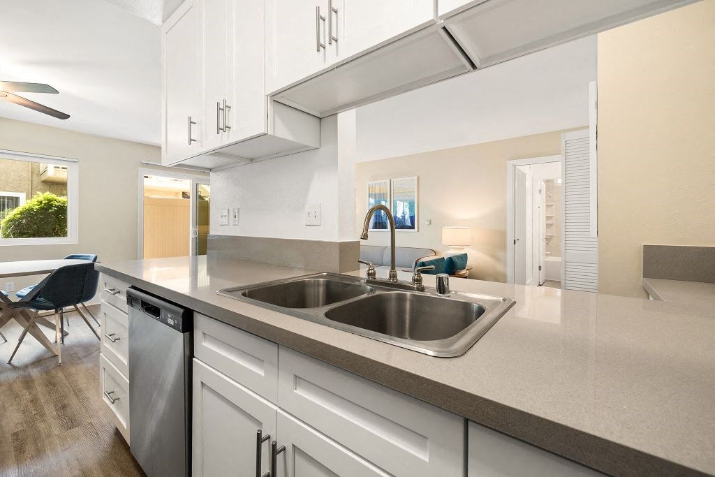 Kitchen Featuring Double Sink, White Cabinetry, and Dishwasher at Casa De Marina Apartments, Los Angeles, CA 90066