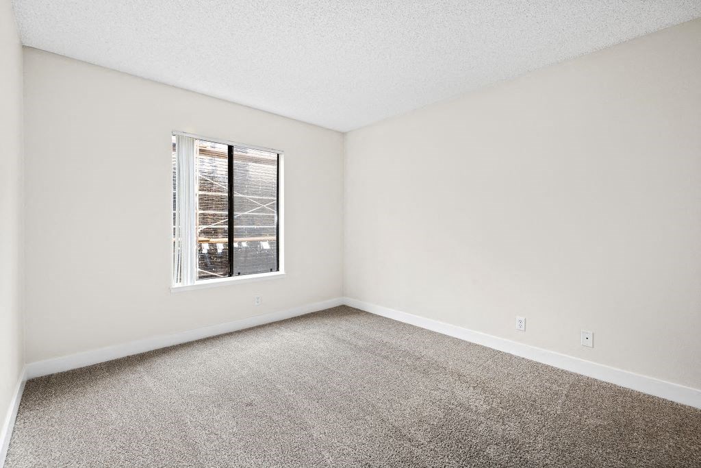 a bedroom with a large window at Woodland Trio Apartments, North Hollywood, California