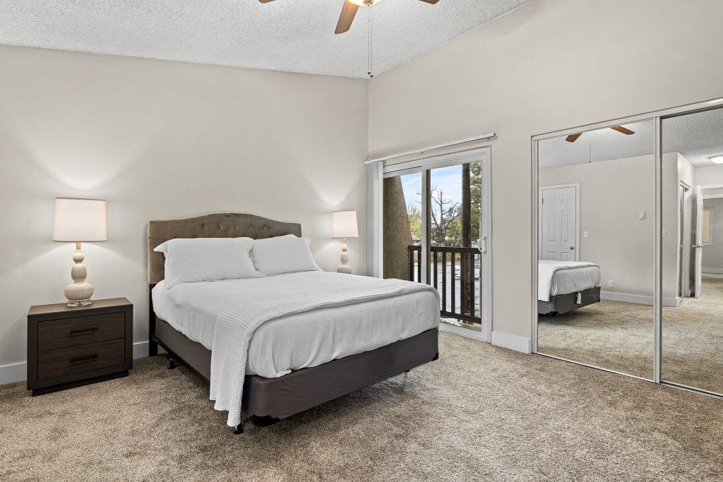 a bedroom with a bed and a mirror