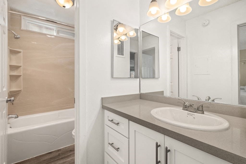 Bathroom with Separate Bathtub, Large Vanity Mirror, and Wood-Style Floors at Casa De Marina Apartments, California 90066