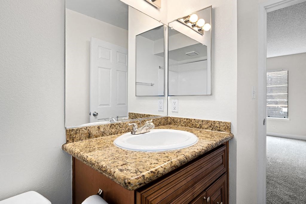 a bathroom with a sink and a mirror at Woodland Trio Apartments, California, 91601