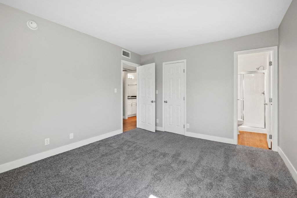 wall to wall carpet, stylish decor, and white walls at The Reserve at Warner Center, California